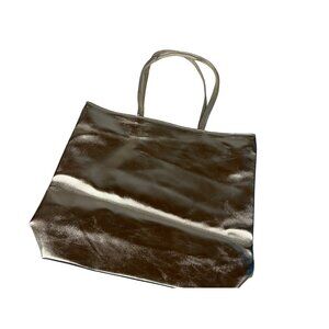 Chic metallic silver tote bag from Macy’s. Roomy interior with slip and zip pock